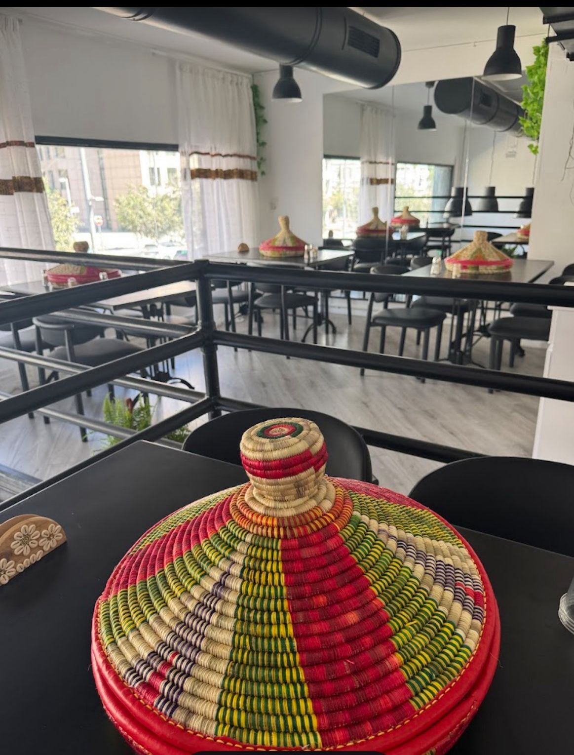 Ge'ez dining room with traditional mesob basket centerpiece